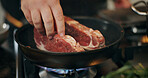 Cooking, stove and hands of chef with steak in pan in kitchen for culinary skill, recipe and meal prep. Food, dinner and person with beef, meat and spice for gourmet dish, ingredients and cuisine