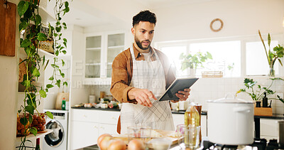 Buy stock photo Man, tablet and ingredients in kitchen for recipe, home and internet instructions for cooking food. Technology, blog and preparation with chef person in apartment for diet, health or nutrition