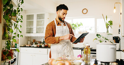 Buy stock photo Man, tablet and cooking with kitchen, recipe and home with food ingredients and internet instructions. Technology, blog and preparation with chef person in apartment for diet, health or nutrition