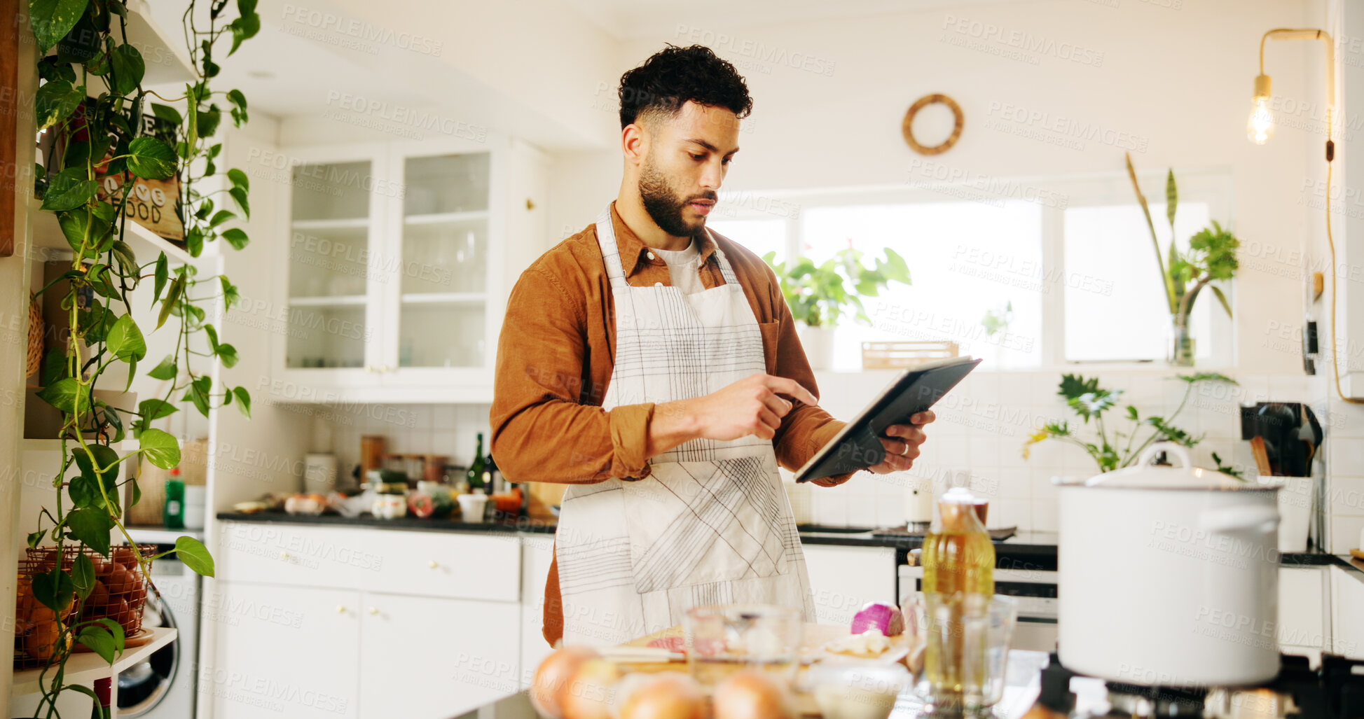 Buy stock photo Man, tablet and cooking with kitchen, recipe and home with food ingredients and internet instructions. Technology, blog and preparation with chef person in apartment for diet, health or nutrition