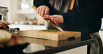 Person, hands or chef with knife in kitchen for meal prep, dinner or catering service at home. Closeup, culinary artist or chopping board with ingredients or herbs for hospitality, recipe or flavor