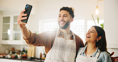 Buy stock photo Happy couple, kitchen and cooking with selfie for photography, picture or memory together at home. Man, woman or lovers with smile for meal prep, social media or capture moment in apron at house