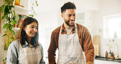 Buy stock photo Couple, happy and cooking in kitchen, home and partnership with support, nutrition or food for meal prep. People, man and woman with smile, apron and excited with help, diet and bonding at apartment