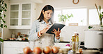 Woman, tablet and research with kitchen, recipe and home for food ingredients and internet instructions. Technology, cooking or preparation with chef person in apartment for diet, health or nutrition