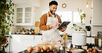 Man, tablet and smile with kitchen, cooking and home with food ingredients and internet recipe instructions. Tech, blog and preparation with chef person in apartment for diet, health or nutrition