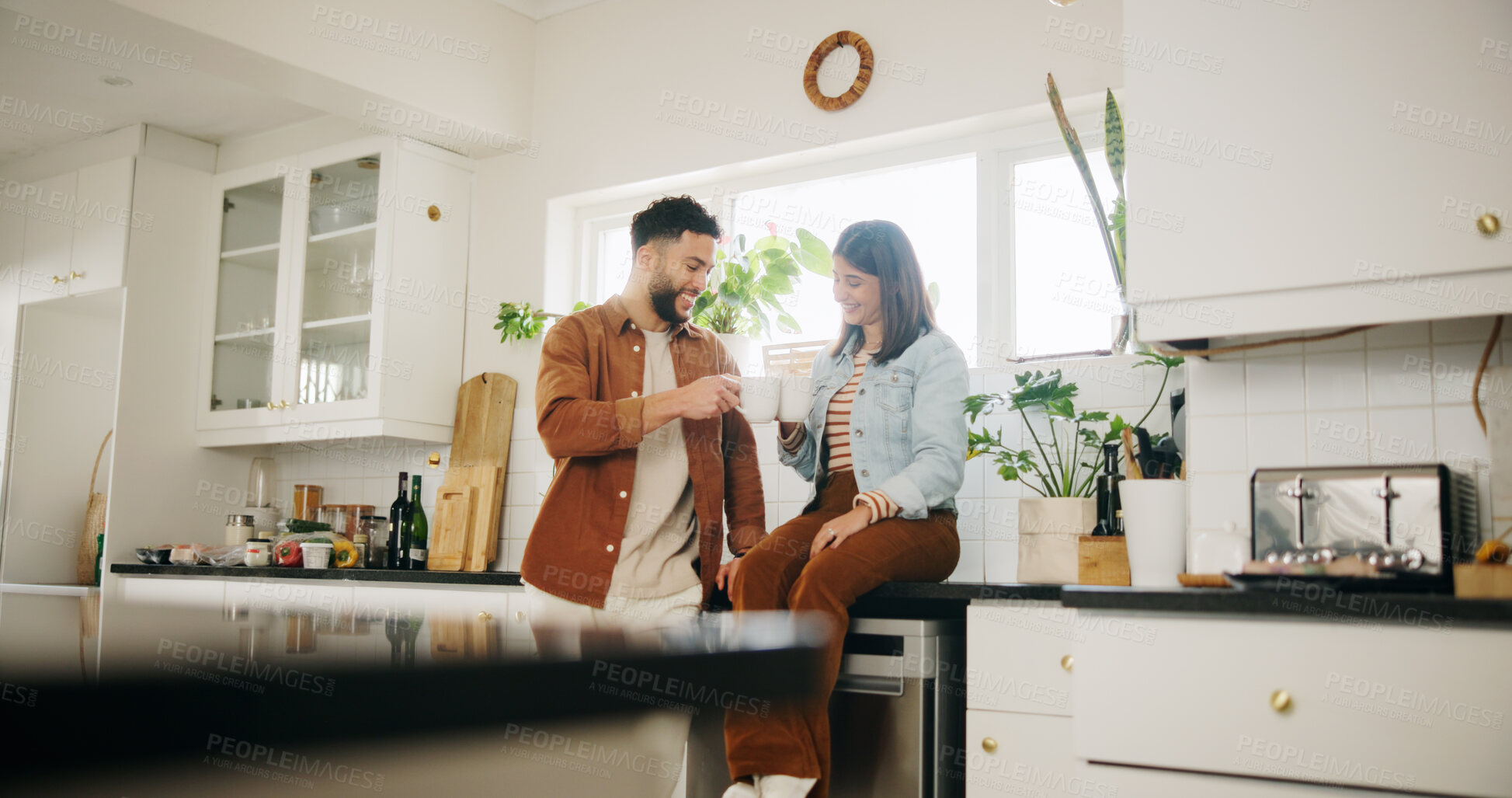 Buy stock photo Home, couple and smile with coffee for toast, celebration and anniversary for relationship in morning. Kitchen, man and woman with cappuccino drink for cheers, love commitment and bonding in marriage