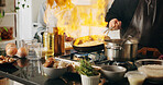 Cooking, pan and hands of man with fire in house kitchen for diet, private service and nutrition. People, recipe and personal chef frying food with flame for gourmet cuisine, hospitality or lunch