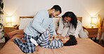 Parents, child and play on bed in family home for bonding, tickle or energy at night. Interracial dad, kid and funny game with mother in bedroom for love, care or laugh together with happy foster boy