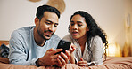 Couple, relax and browsing with phone on bed for social media, online streaming or entertainment at home. Man, woman or lovers lying in bedroom with mobile smartphone for network connection at house