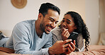 Happy couple, relax or laughing with phone on bed for online entertainment, humor or comedy at home. Man, woman or lovers with smile on mobile smartphone for movie or subscription in bedroom at house