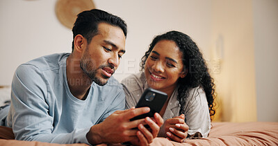 Buy stock photo Happy couple, relax or browsing with phone on bed for online entertainment, humor or comedy at home. Man, woman or lovers with smile on mobile smartphone for movie or subscription in bedroom at house
