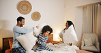 Pillow fight, family and playing in bedroom, laughing and happiness in morning, parents and fun with son. Home, man and woman with smile for game, mom and dad with energy in apartment or together
