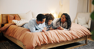 Buy stock photo Bedroom, family and parents with child, tablet and watching movies on website, entertainment and online. Bonding, woman and man with son in home, streaming and smile for comedy film in apartment