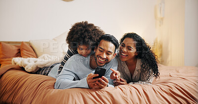 Buy stock photo Happy family, relax and laughing with phone on bed for funny joke, meme or social media at home. Mom, dad and child with smile for comedy, humor or online entertainment on mobile smartphone at house