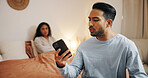 Frustrated couple, phone and bed with fight for cheating affair, trust issues or argument at home. Upset, man or woman with mobile smartphone in bedroom for toxic relationship, conflict or divorce