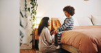 Mom, child and talking in bedroom with holding hands, discipline and ready for bedtime at night. Mother, boy and relax in home with storytelling, conversation and bonding in evening with support