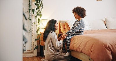 Buy stock photo Mom, child and talking in bedroom with holding hands, discipline and ready for bedtime at night. Mother, boy and relax in home with storytelling, conversation and bonding in evening with support