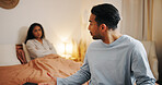 Upset couple, bed and fight with argument for cheating affair, trust issues or disagreement at home. Frustrated, man or woman with dispute in bedroom for toxic relationship, conflict or divorce