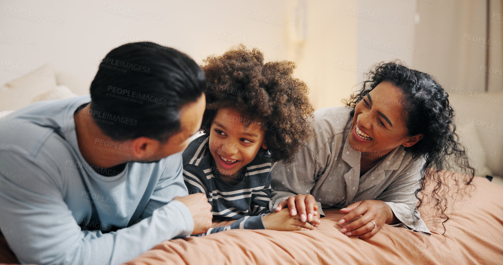 Buy stock photo Bedroom, parents and bonding with child, laughing and listening to boy with joke, happy or talking. Morning, man and woman with smile for conversation, relax and kid with funny story, family and home
