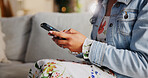 Home, sofa and hands with smartphone for connection, online contact and chat on social media. Closeup, person and technology with application for text message, blog website and relax in living room