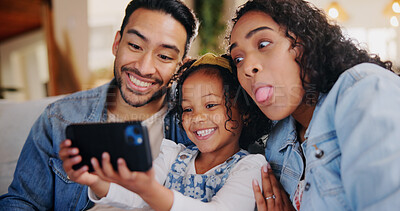 Buy stock photo Parents, happy and laugh with selfie on sofa, playful and bonding with post on web in family home. People, mother and father with child, photography and comic joke with love in living room at house