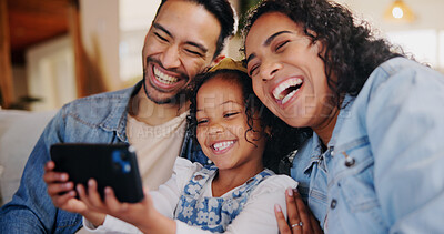 Buy stock photo Parents, girl and laugh with phone on sofa with streaming, happy and bonding with funny video in family home. People, mother and dad with child, smartphone and mobile app with comic cartoons in house