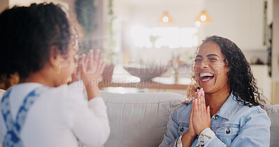 Buy stock photo Games, mother and girl with hands together, home and playing with fun, break and bonding in lounge. Family, apartment and parent on couch, mama and daughter with motor skills, funny and happiness