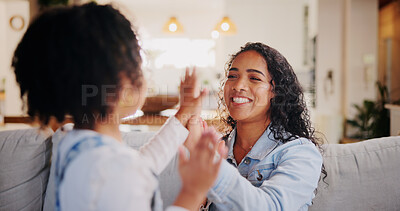 Buy stock photo Games, mother and girl with hands together, smile and playing with fun for bonding in lounge. Family, home and parent on couch, mama and daughter with motor skills, excited and happy with love