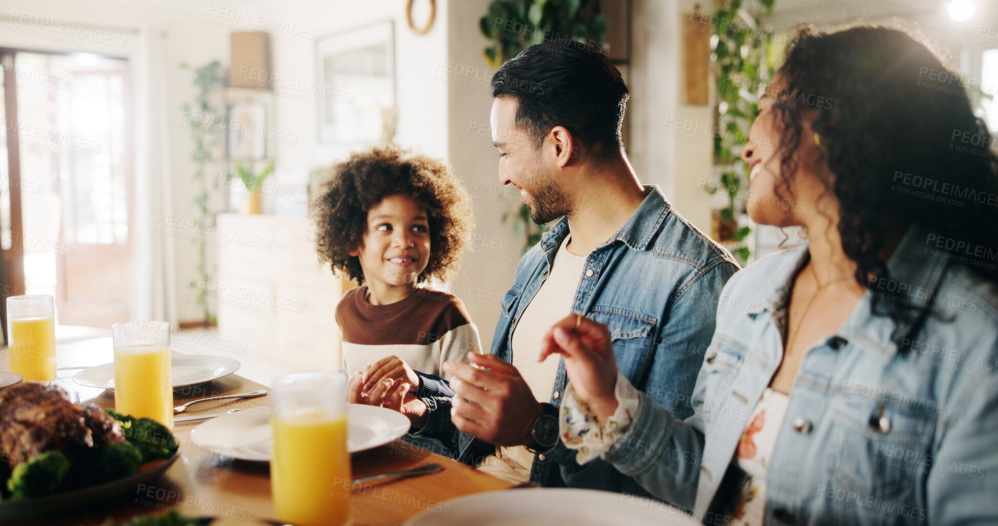 Buy stock photo Dinner, happy and parents with child in home for family gathering, healthy feast and bonding at dining table. Support, interracial people and eating together for nutrition, lunch event and connection