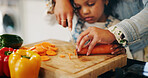 Hands, mother and child with vegetables to chop, cooking and bonding with learning skills at home. Kitchen, girl and mom with teaching for cutting, organic food and meal prep with carrots as family