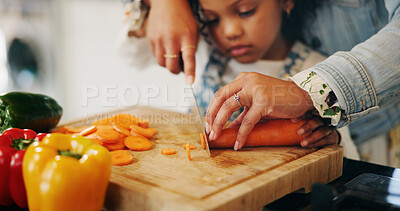 Buy stock photo Hands, mother and child with vegetables to chop, cooking and bonding with learning skills at home. Kitchen, girl and mom with teaching for cutting, organic food and meal prep with carrots as family