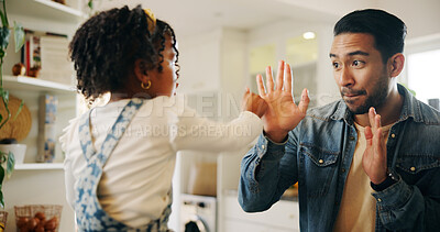 Buy stock photo Fun, game and hands with father, girl and kitchen of home together for bonding. Support, love and boxing with single parent, man and daughter playing in apartment for motor skills development