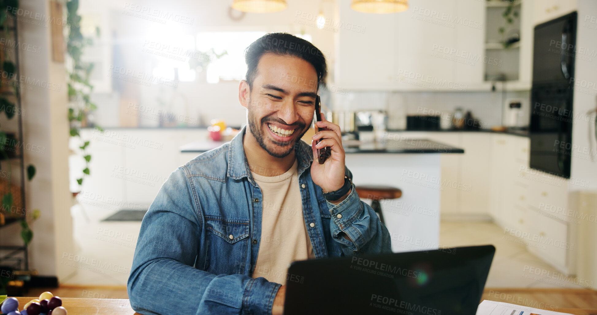 Buy stock photo Smile, phone call and man in kitchen with laptop checking social media, networking and remote work. Home office, computer and freelance blog writer in house with smartphone for online communication