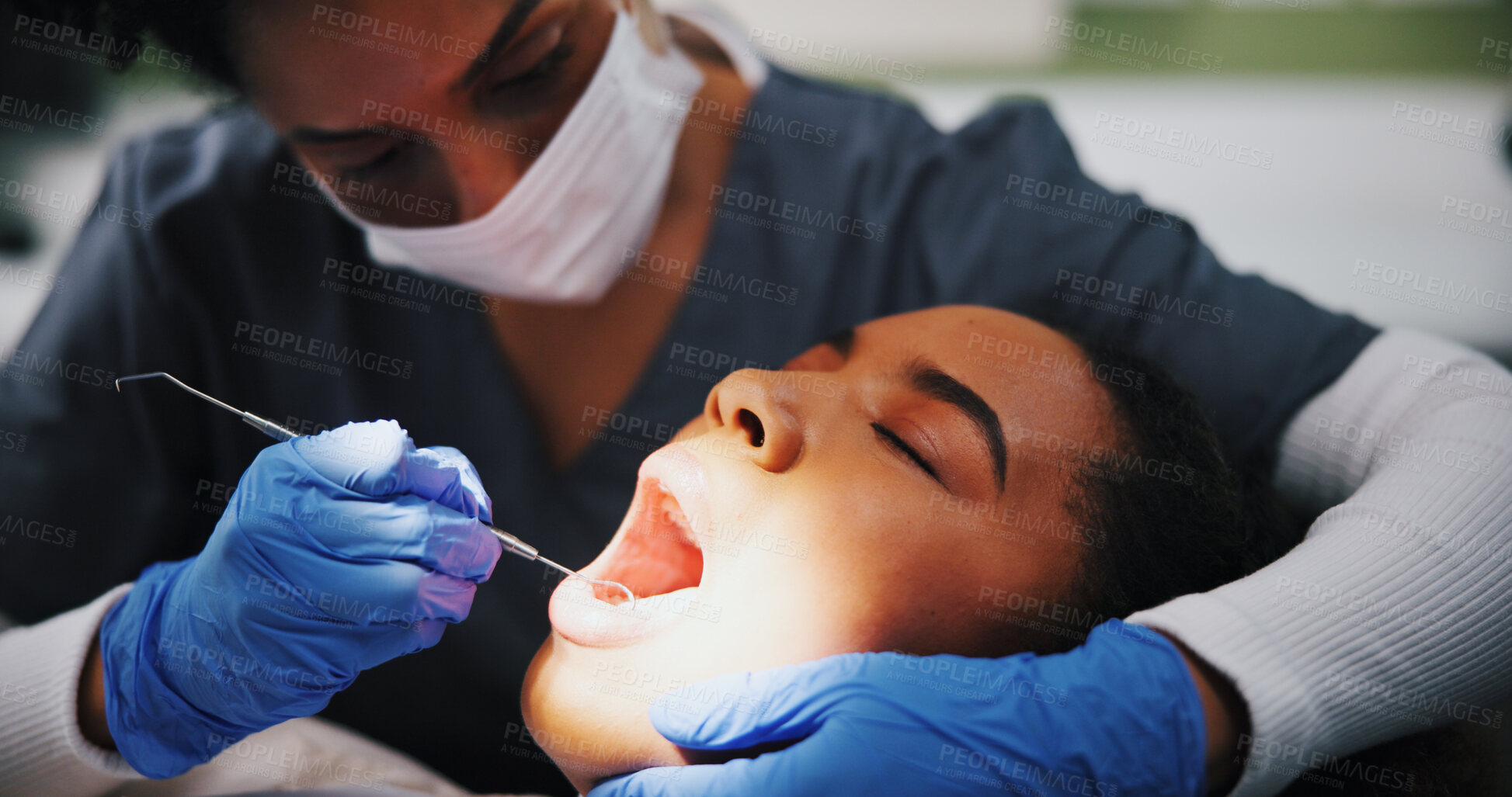 Buy stock photo Woman, dentist and tools in consultation for dental care, plaque removal and cavity inspection in light. Patient, orthodontist and oral examination in practice for cleaning, check gums and service