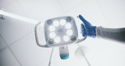 Buy stock photo Bright, theatre and hand with surgical light, medical or intense illumination for surgeon or operation. Hospital, health and person with gloves for safety, PPE or expert with equipment for visibility
