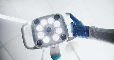 Buy stock photo Light, medical and operation with hand of dentist closeup in clinic for checkup from below. Appointment, healthcare and dental with medicine professional in hospital for oral hygiene treatment