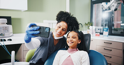 Buy stock photo Dentist, woman and child with selfie at hospital, happy or excited for results, cleaning or tooth extraction. People, girl and smile with teeth whitening, care and photography with doctor at clinic