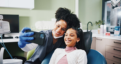 Buy stock photo Dentist, woman and child with selfie, happy and excited for results, cleaning or tooth extraction at clinic. People, girl and smile with teeth whitening, care and photography with doctor at hospital