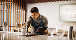 Cocktail, cafe and bartender man with tablet for recipe research, stock management or online order. Mixology, drinks or server on digital app for inventory checklist, menu planning and small business