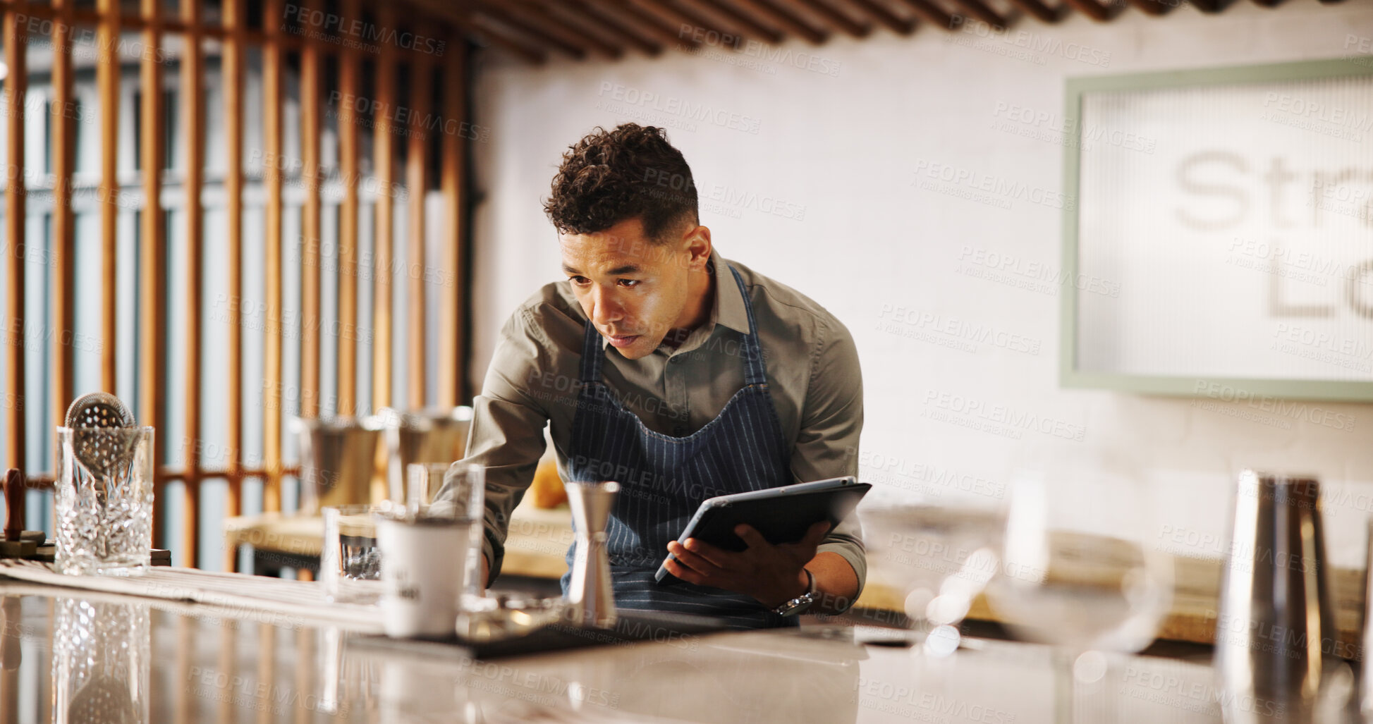 Buy stock photo Cocktail, cafe and bartender man with tablet for recipe research, stock management or online order. Mixology, drinks or server on digital app for inventory checklist, menu planning and small business