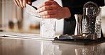 Cocktail, cafe and hands of bartender man with glass, ice and tools for artisan beverage recipe. Mixology, small business pub and barman at counter with happy hour drinks, process and craft alcohol