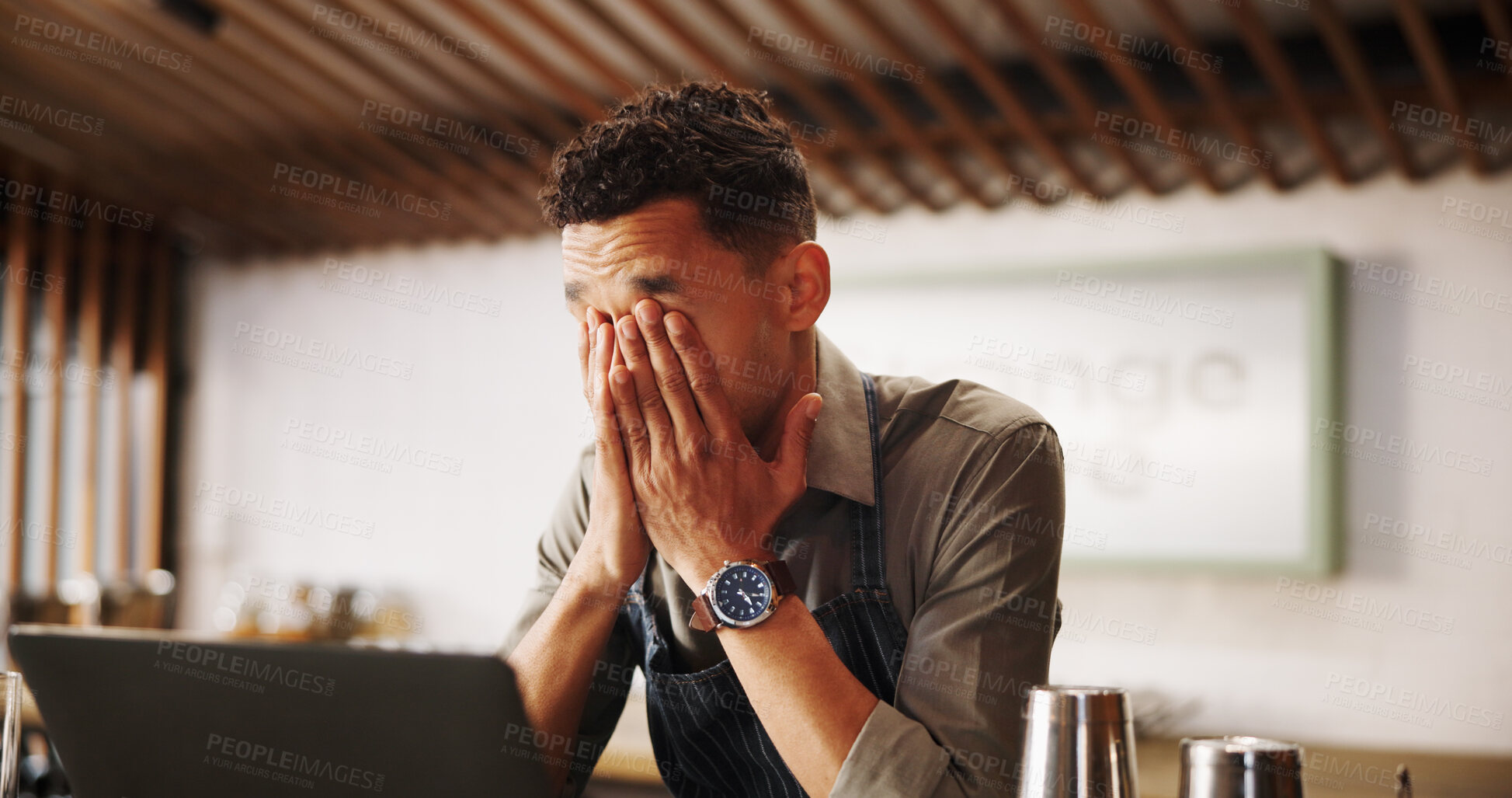 Buy stock photo Frustrated man, barista and laptop with mistake for fatigue, eye strain or company bankruptcy at restaurant. Male person, bartender or overworked on computer for fail, loss or debt at indoor bar