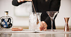 Cocktail, mixology and hands of bartender with glass, ice and tools for artisan beverage recipe. Cafe, small business pub and man at bar counter with happy hour drinks, process and craft alcohol