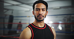 Serious, boxer and portrait of man in gym for mma fighter, workout and training practice. Wresting challenge, martial arts club and sports with person and boxing ring for exercise, fitness and battle
