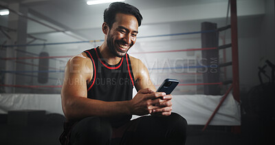 Buy stock photo Man, phone and happy at gym by boxing ring with chat, contact and texting for notification at training center. Person, athlete or fighter with smartphone, smile and social media at martial arts club
