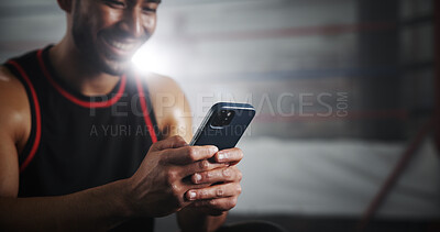 Buy stock photo Hands, phone and texting at gym by boxing ring with notification for invite to global contest at training center. Person, athlete and fighter with smartphone, happy and chat at martial arts club