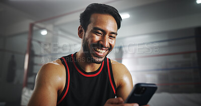 Buy stock photo Man, phone and texting at gym by boxing ring with chat, contact and happy for notification at training center. Person, athlete or fighter with smartphone, smile and social media at martial arts club