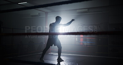 Buy stock photo Person, silhouette and boxing in ring for training, punch and power with routine for combat sports. Athlete, fighter and mixed martial arts with workout, fitness and ready for competition at club