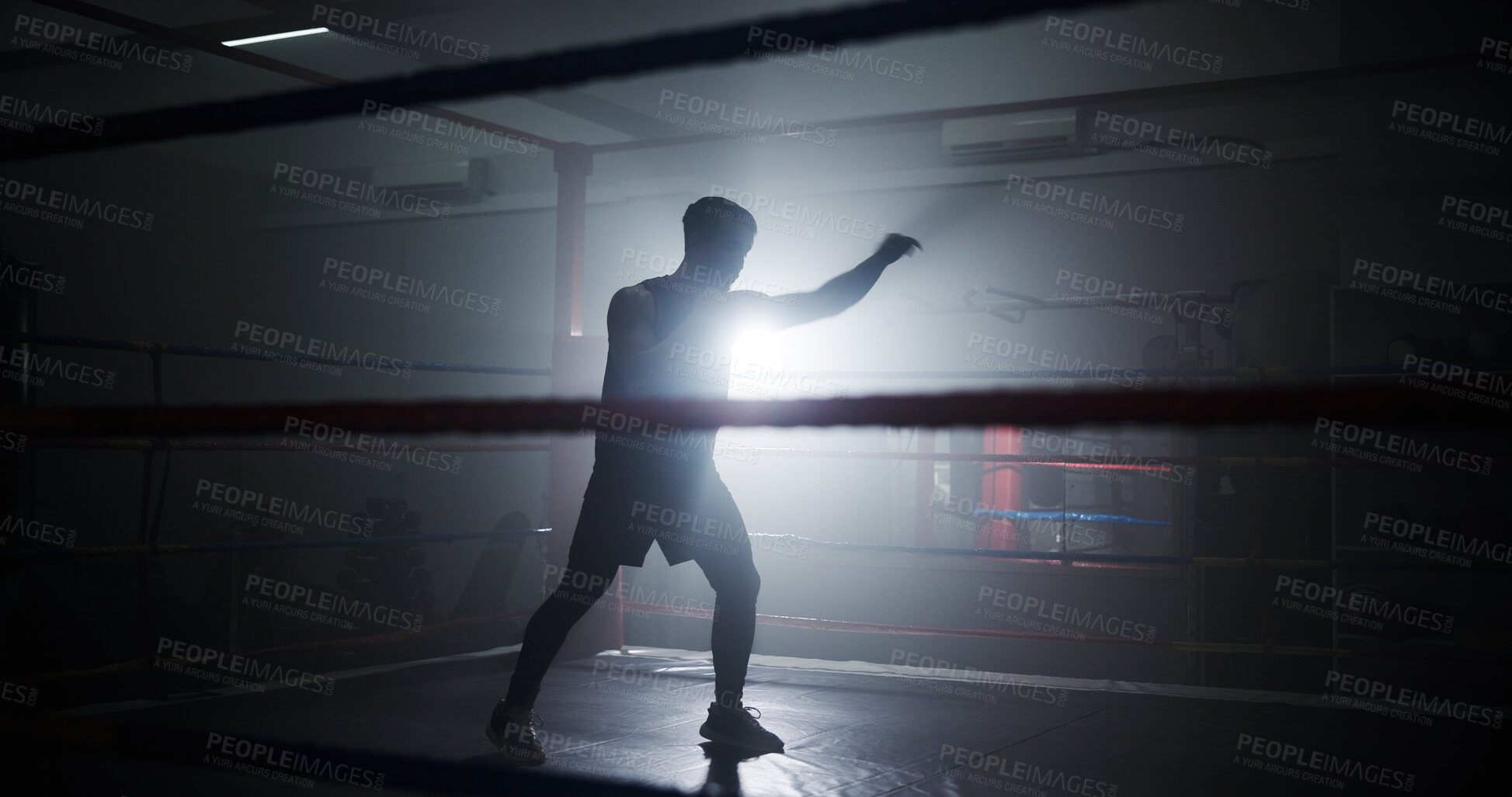 Buy stock photo Person, silhouette and boxing in ring for training, punch and power with routine for combat sports. Athlete, fighter and mixed martial arts with workout, fitness and ready for competition at club