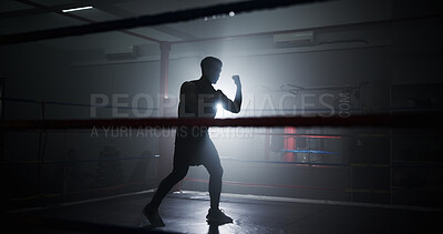 Buy stock photo Person, silhouette and boxing in ring with punch, training and power with routine for combat sports. Athlete, fighter and mixed martial arts with workout, fitness and ready for competition at club